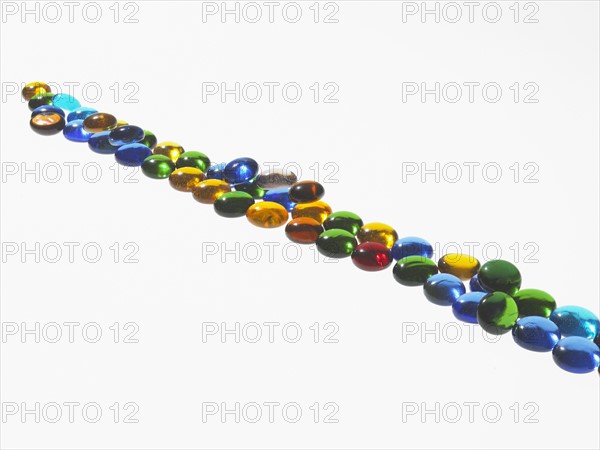 Studio shot of colorful glass beads in line. Photo : David Arky