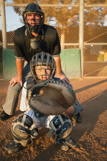 USA, California, Ladera Ranch, man and boy (10-11) playing baseball.