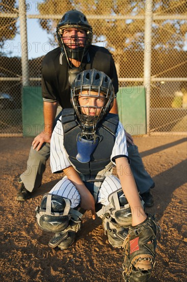 USA, California, Ladera Ranch, man and boy (10-11) playing baseball.