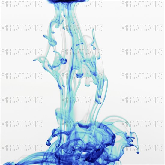 Studio shot of blue dye in abstract shape. Photo : David Arky