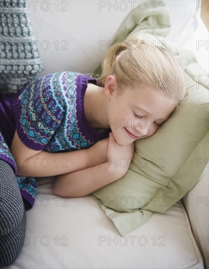 USA, New Jersey, Jersey City, Girl (8-9) sleeping on sofa. Photo : Jamie Grill Photography