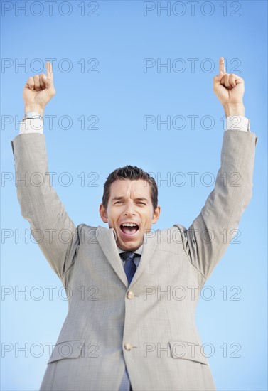 South Africa, Happy businessman, low angle view. Photo : momentimages