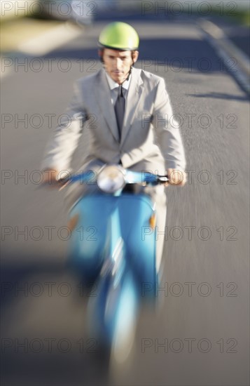 South Africa, Businessman driving scooter, high angle view. Photo : momentimages