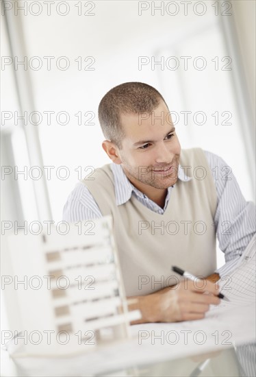 South Africa, Smiling architect working in office. Photo : momentimages