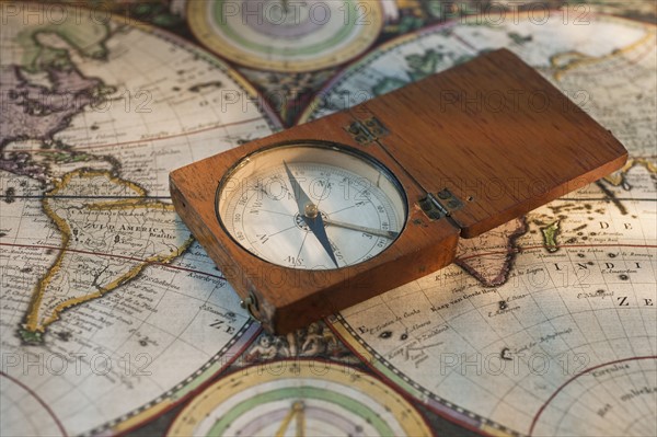 Antique compass on map.