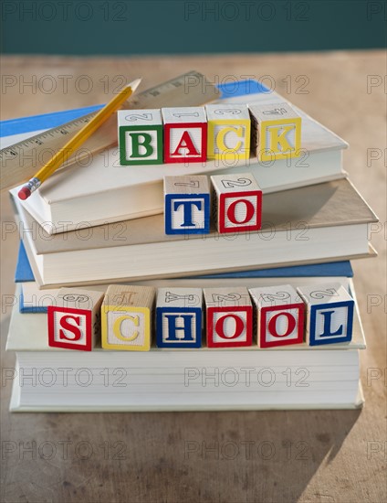 Back to school building blocks on stacked books pencil and ruler.