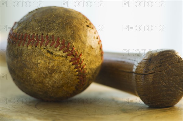 Antique baseball with baseball bat.