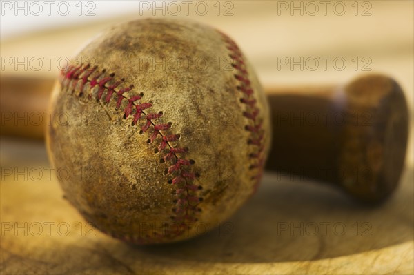 Antique baseball with baseball bat.