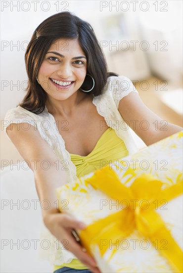 USA, New Jersey, Jersey City, Young attractive woman showing gift. Photo : Daniel Grill
