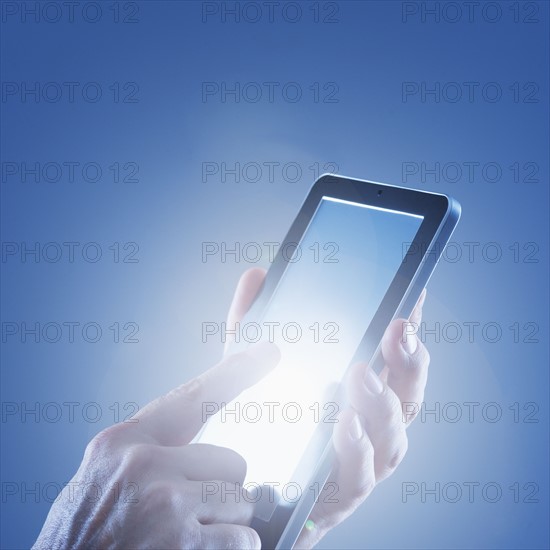 Young woman's hands using digital tablet.