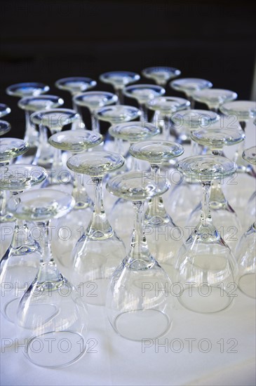 Rows of wine glasses on table .