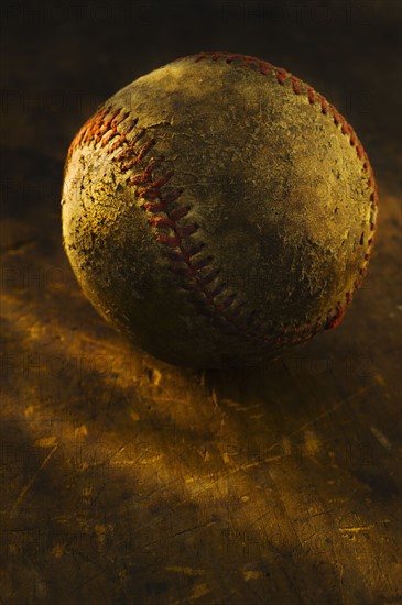 Antique baseball on wooden floor.