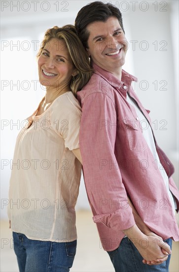 USA, New Jersey, Jersey City, Portrait of couple standing back to back.