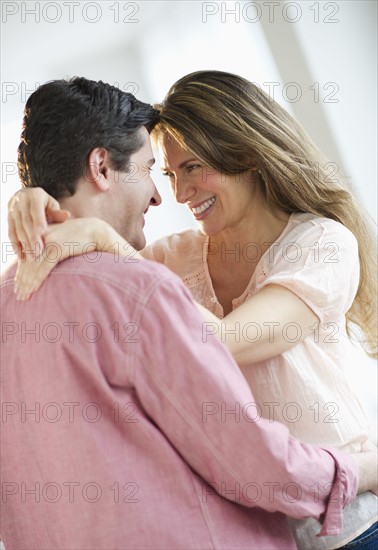 USA, New Jersey, Jersey City, Couple embracing, smiling.