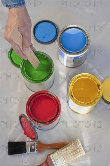 Cans with colorful paint.