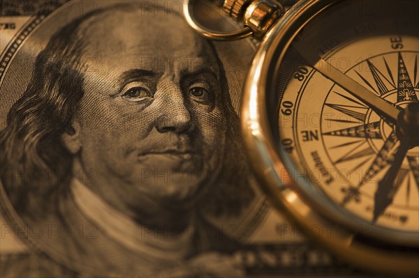 Compass on dollar bill. Photo : Daniel Grill