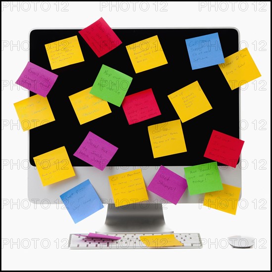 Computer monitor covered with colorful adhesive notes. Photo : Mike Kemp