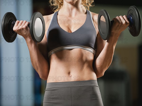 USA, California, Los Angeles, woman exercising with dumbbells.