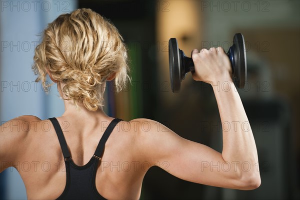 USA, California, Los Angeles, woman exercising with dumbbells.