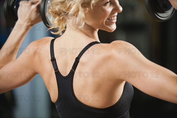 USA, California, Los Angeles, woman exercising with dumbbells.