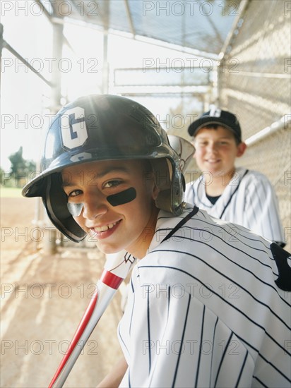 USA, California, Ladera Ranch, boys (10-11) from little league baseball team on dugout.