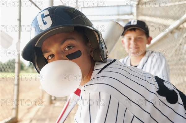 USA, California, Ladera Ranch, boys (10-11) from little league baseball team on dugout.