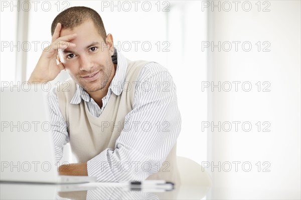 South Africa, Portrait of young man with laptop. Photo : momentimages