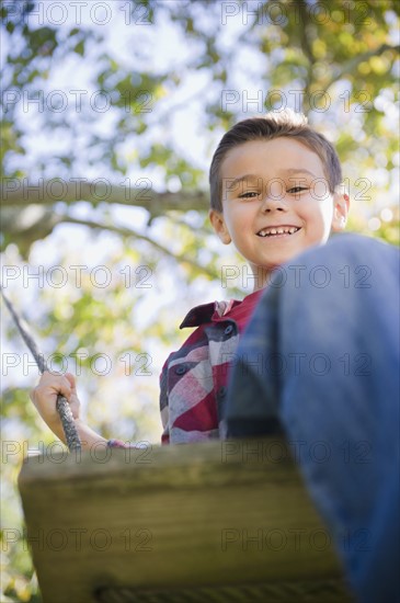 USA, New York, Flanders, Boy (8-9) playing in garden. Photo : Jamie Grill Photography