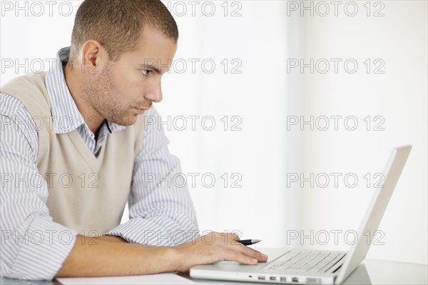 South Africa, Portrait of young man with laptop. Photo : momentimages