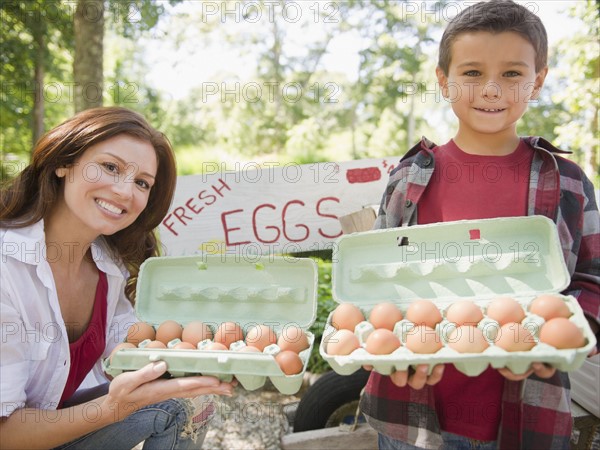 USA, New York, Flanders, Mother and son (8-9) selling fresh eggs. Photo : Jamie Grill Photography