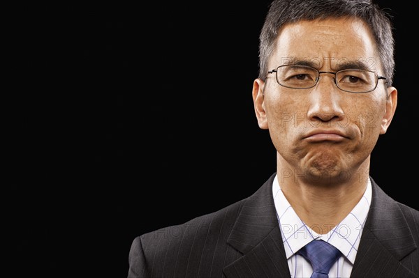 Studio portrait of sulking businessman. Photo : FBP