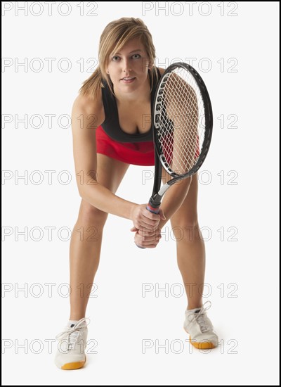 Young woman holding tennis racket. Photo : Mike Kemp