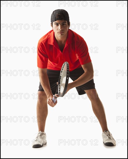 Young man playing tennis. Photo : Mike Kemp