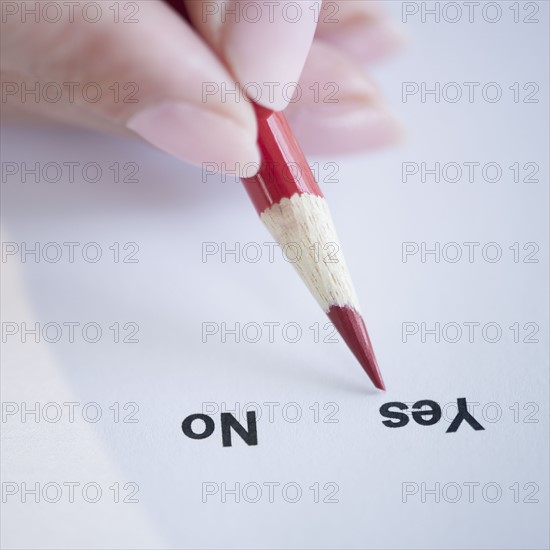 USA, New Jersey, Jersey City, Close-up view of woman's hand filling in form. Photo : Jamie Grill Photography