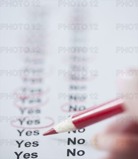 USA, New Jersey, Jersey City, Close-up view of woman's hand filling in form. Photo : Jamie Grill Photography