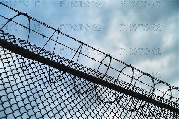 USA, New York, New York City, Barbed wire fence.