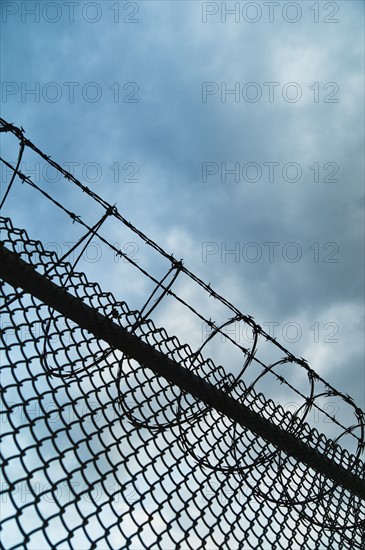 USA, New York, New York City, Barbed wire fence.