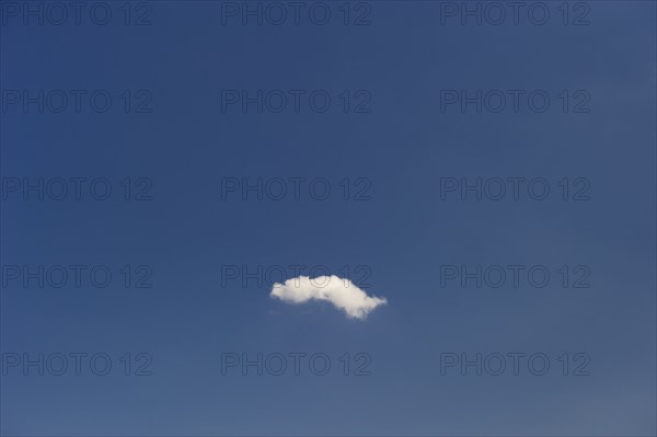 Single cloud in blue sky.