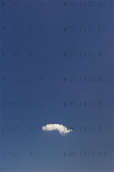 Single cloud in blue sky.