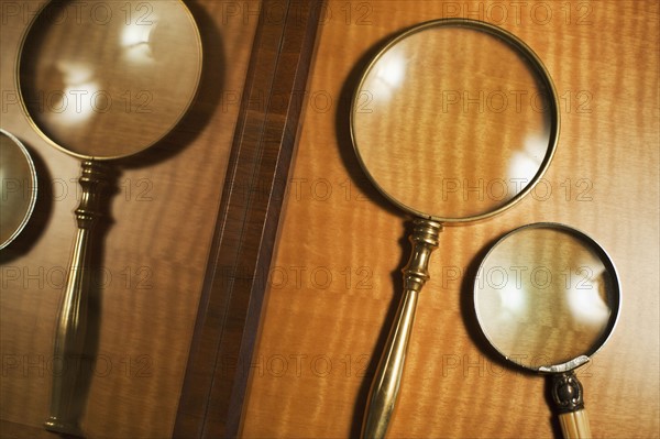 USA, New Jersey, Jersey City, Two magnifying glasses reflected in mirror.