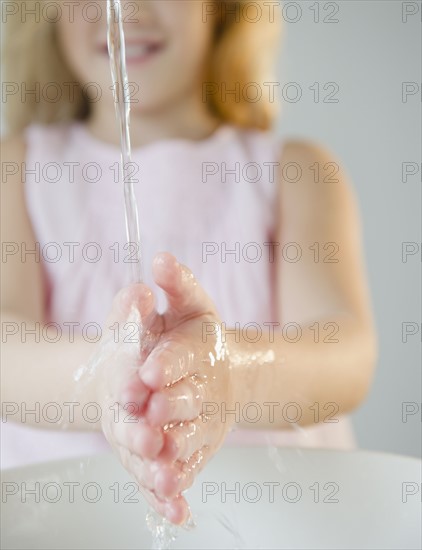 USA, New Jersey, Jersey City, Close-up view of girl (8-9) washing hands. Photo : Jamie Grill Photography