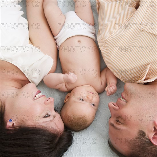 USA, New Jersey, Jersey City, Family with baby daughter (2-5 months) laying upside down. Photo : Jamie Grill Photography