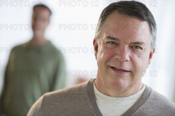 USA, New Jersey, Jersey City, Portrait of man with son in background.