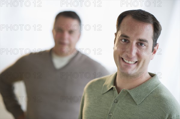 USA, New Jersey, Jersey City, Portrait of man with father in background.