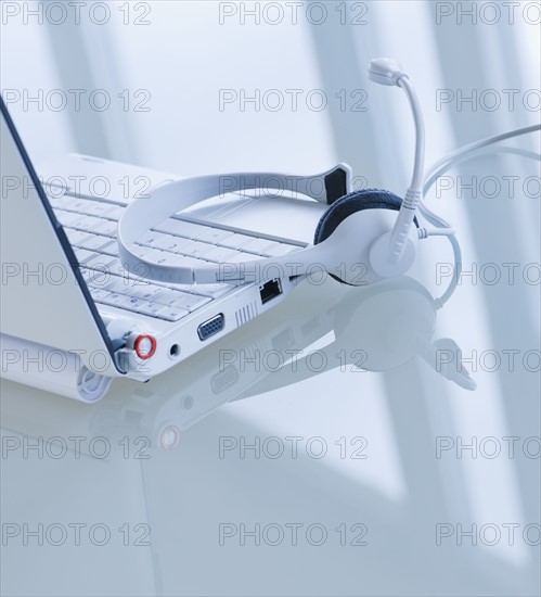 USA, New Jersey, Jersey City, Close-up view of open laptop and headset . Photo : Daniel Grill
