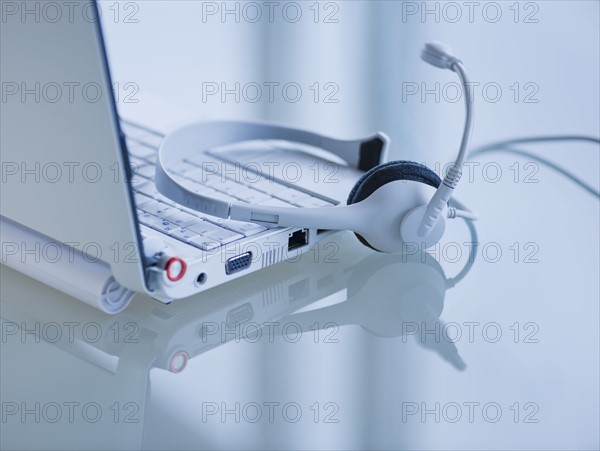 USA, New Jersey, Jersey City, Close-up view of open laptop and headset . Photo : Daniel Grill