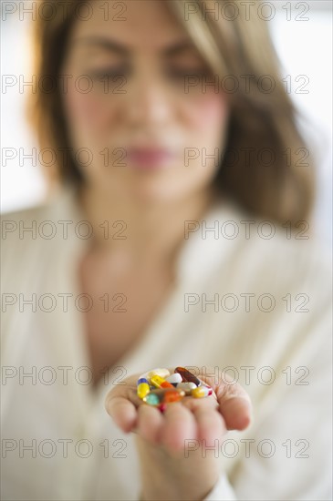 USA, New Jersey, Jersey City, Woman holding pills.