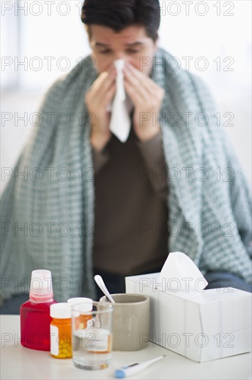 USA, New Jersey, Jersey City, Man with flu, blowing nose.