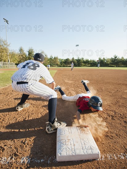 Boys (10-11) playing baseball.