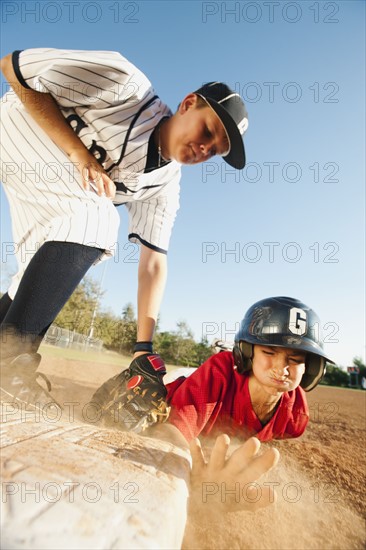 Boys (10-11) playing baseball.